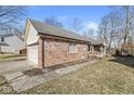 Brick house exterior with a two-car garage and a covered front porch with a wooden bench at 851 Westridge Cir, Noblesville, IN 46062