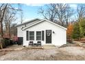 White house with gray accents, featuring a small front porch and stone driveway at 8598 S Riser Dr, Nineveh, IN 46164
