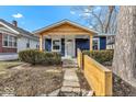 Charming blue bungalow with wood accents and landscaped walkway at 916 N Bradley Ave, Indianapolis, IN 46201