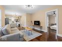 Sunlit living room boasting hardwood floors, modern lighting, and comfortable seating arrangement at 916 N Bradley Ave, Indianapolis, IN 46201