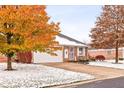 Brick ranch home with attached garage and autumn landscaping; light snow on the ground at 1437 Holiday W Ln, Brownsburg, IN 46112