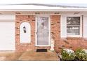 Brick front entry with white door, arched entryway, and angel statue at 1437 Holiday W Ln, Brownsburg, IN 46112