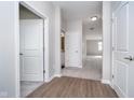 Hardwood floor hallway with doors to bedrooms and bath at 1623 Capra Ct, Beech Grove, IN 46107