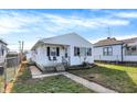 White house with a small front porch and walkway, nice lawn at 1837 E Legrande Ave, Indianapolis, IN 46203
