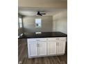 White kitchen island with granite countertop, offering extra workspace and storage at 2414 Walker Ave, Indianapolis, IN 46203