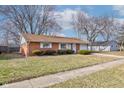 Brick ranch house with attached garage and landscaped yard at 2832 S Oakland Ave, Indianapolis, IN 46203