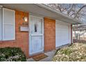 White front door with security screen and welcome mat at 2832 S Oakland Ave, Indianapolis, IN 46203
