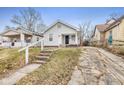 Cute bungalow home with a small front yard and driveway at 2875 Adams St, Indianapolis, IN 46218