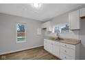 Renovated kitchen featuring white cabinets and new flooring at 2875 Adams St, Indianapolis, IN 46218