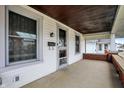 Inviting covered porch with classic columns and view of neighboring homes at 403 Colescott St, Shelbyville, IN 46176