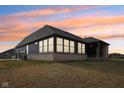 A home's backyard showcases expansive windows and a covered porch, perfect for outdoor living and entertainment at 5106 Zinnia Dr, Plainfield, IN 46168