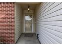 Front entry with glass door and brick and siding exterior at 5364 Milhouse Rd, Indianapolis, IN 46221