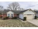 Brick and vinyl-sided ranch home with attached garage and landscaping at 5364 Milhouse Rd, Indianapolis, IN 46221