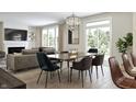 Open concept dining room and living room with hardwood floors and modern decor at 552 Bluestem Ln, New Whiteland, IN 46184