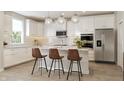 Modern white kitchen with an island, stainless steel appliances, and subway tile backsplash at 552 Bluestem Ln, New Whiteland, IN 46184