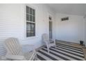 Front porch with two chairs and a striped rug at 5965 Grassy Rd, Lebanon, IN 46052