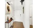 Bright entryway with hardwood floors and modern console table at 630 N College Ave # 401, Indianapolis, IN 46204