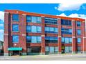 Brick building with large windows and green awning at 630 N College Ave # 401, Indianapolis, IN 46204