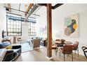 Open living area with hardwood floors and large windows at 630 N College Ave # 401, Indianapolis, IN 46204