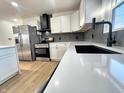 Well-lit kitchen with stainless steel appliances, white cabinetry, and a modern aesthetic at 6775 N County Road 550 E, Brownsburg, IN 46112