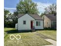 Single-story house with a well-kept lawn, a bright red door, and a cozy appeal at 711 W 24Th St, Anderson, IN 46016