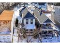 Aerial view of a house with a dark roof and fenced backyard during the winter season at 747 E Mccarty St, Indianapolis, IN 46203