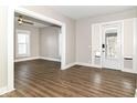 Bright living room with wood-look floors and fresh paint, featuring a large window at 747 E Mccarty St, Indianapolis, IN 46203