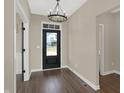 Inviting entryway with a modern chandelier and dark wood-look flooring at 97 Hampstead Ct, Westfield, IN 46074