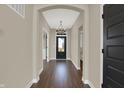 Open entryway featuring dark wood floors, a chandelier, and views to other rooms at 97 Hampstead Ct, Westfield, IN 46074