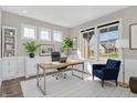 Bright home office featuring built-in shelving, large windows, and modern furnishings at 97 Hampstead Ct, Westfield, IN 46074