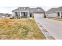 Charming home with a brick-accented facade, two-car garage, and manicured landscaping at 9866 Olympic Blvd, Pendleton, IN 46064
