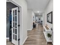 Inviting hallway with wood floors and sight lines into living spaces at 9866 Olympic Blvd, Pendleton, IN 46064