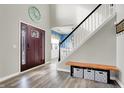 Welcoming entryway with high ceilings, a wood bench, and a glimpse into the dining area with blue walls at 11977 Cobblestone Dr, Fishers, IN 46037