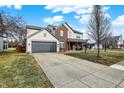 Beautiful two-story home featuring a brick facade, attached two-car garage, and long driveway at 11977 Cobblestone Dr, Fishers, IN 46037