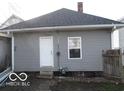 Rear view of a home with gray siding, a back entrance, and a small yard at 1258 W 29Th St, Indianapolis, IN 46208