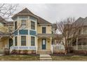 A two-story yellow home with a welcoming covered front porch and blue accents at 12755 Forsyth St, Carmel, IN 46032