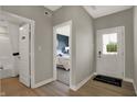 Inviting entryway featuring hardwood floors and neutral paint tones, offering access to a bedroom and the front door at 16960 Sandhurst Pl, Westfield, IN 46074