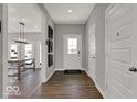 Inviting foyer showcasing hardwood floors, a welcome mat, neutral paint colors, and a view into the home at 16966 Sandhurst Pl, Westfield, IN 46074