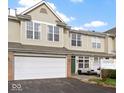 Charming townhouse boasts an attached garage and inviting front patio, perfect for outdoor relaxation at 2231 Colfax Ln, Indianapolis, IN 46260