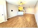 Spacious living room with hardwood floors, a ceiling fan, and abundant natural light at 2231 Colfax Ln, Indianapolis, IN 46260