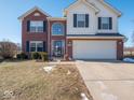 Two-story house featuring a brick and vinyl exterior, a two-car garage, and a well-maintained lawn at 3143 Shadow Lake Dr, Indianapolis, IN 46217
