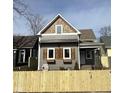 Two-story home with gray siding, decorative wood shutters, and a quaint covered front porch at 350 E Minnesota St, Indianapolis, IN 46225
