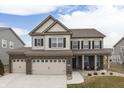 Two-story home with neutral siding, brick accents, and a three-car garage at 3884 Justify Dr, Bargersville, IN 46106