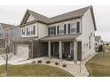 Two-story home with neutral siding, brick accents, and a covered porch at 3884 Justify Dr, Bargersville, IN 46106