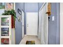 Gray entryway with white door and tile flooring at 397 Polk Village Rd, Greenwood, IN 46143