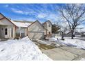 Two-story tan house with attached garage and snow-covered driveway at 397 Polk Village Rd, Greenwood, IN 46143