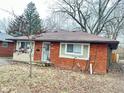 Exterior view of a brick home featuring new windows and a cozy front porch at 4114 N Butler Ave, Indianapolis, IN 46226