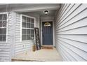 Cozy covered front porch features stylish decor and a 'Welcome' sign, creating a warm entry at 5782 Jamestown Square Ln, Indianapolis, IN 46234