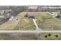 Expansive aerial view showcasing the home's setting on a large lot, surrounded by mature trees and open fields at 5802 Watson Rd, Greenwood, IN 46143