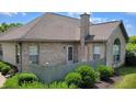 Beautiful brick home featuring a private fenced-in patio and lush greenery, perfect for outdoor relaxation at 5850 Bradston Way, Indianapolis, IN 46237